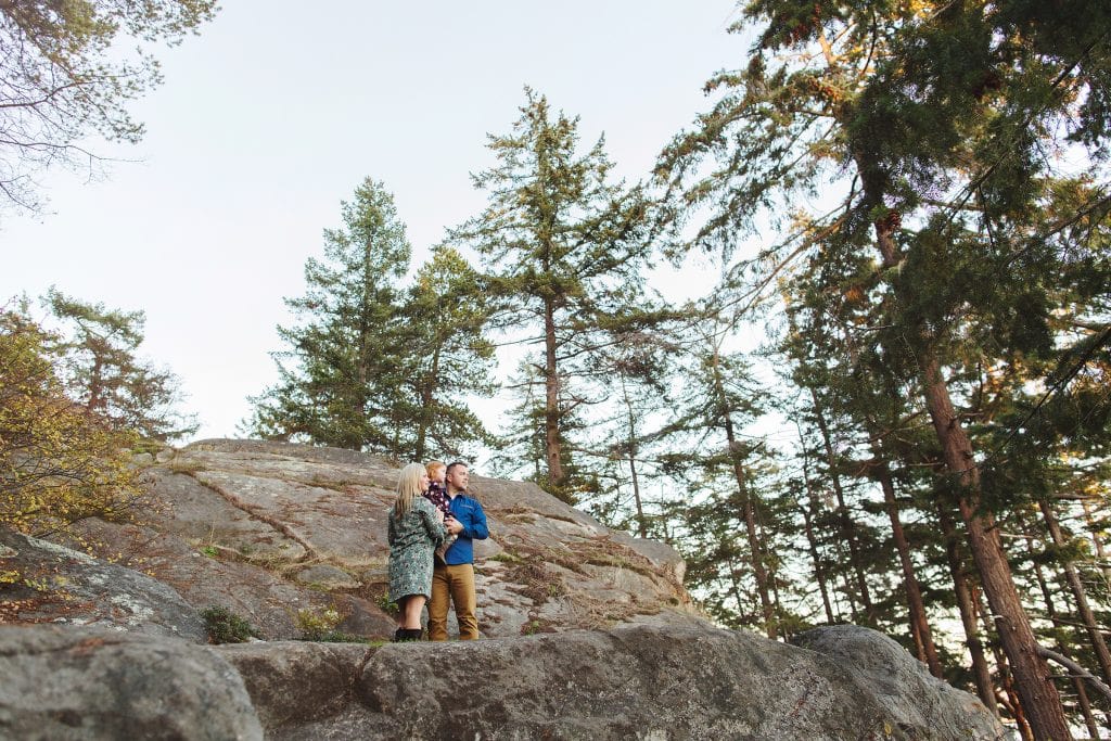 family standing on cliffs at Lighthouse Park in West Vancouver